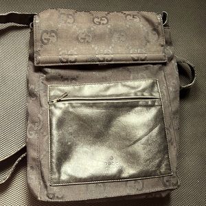 Black Gucci with monogram back pack. Black leather straps. Medium size.